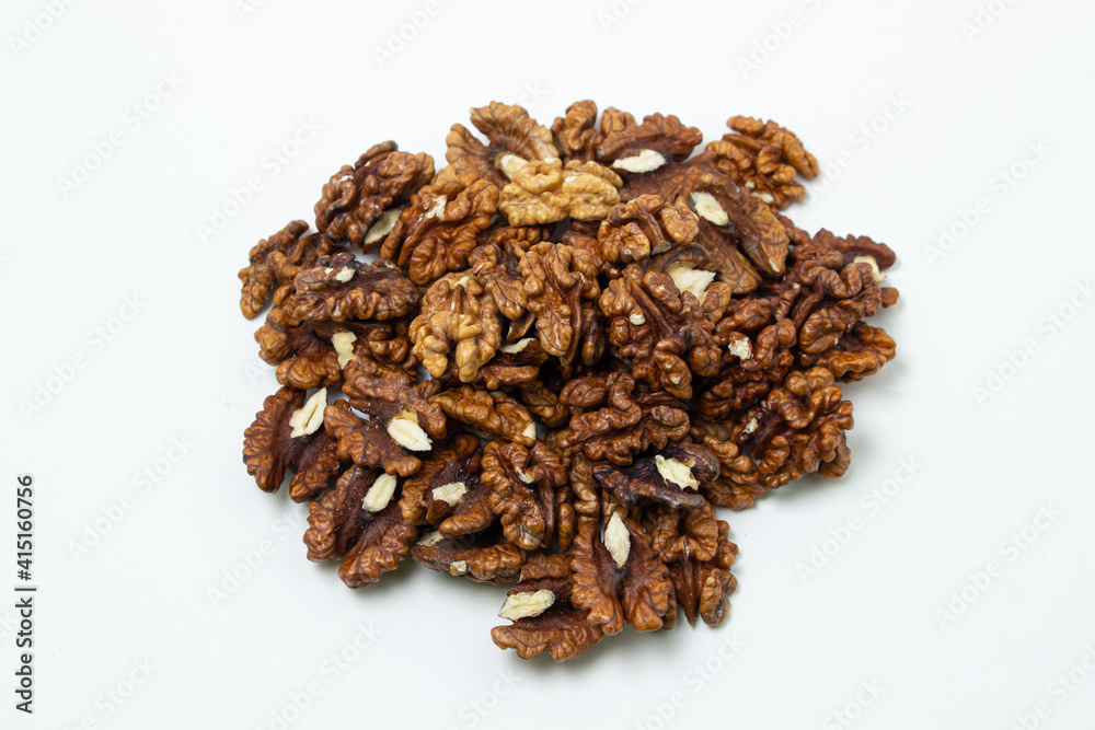 Peeled walnuts on a white background. A bunch of shelled walnuts. Nutritious food