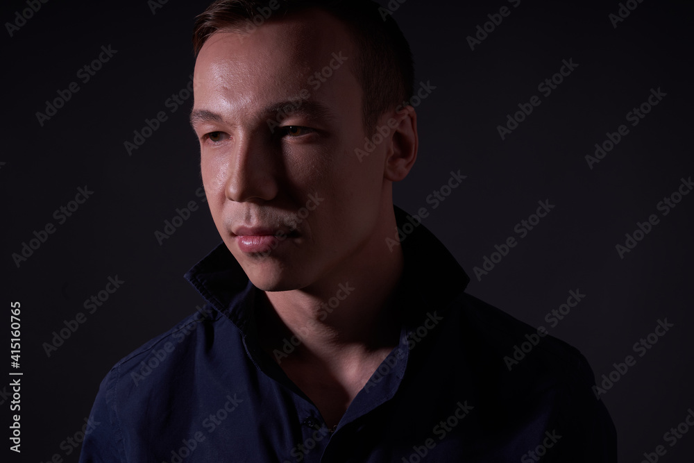 Beautiful young guy on a black background in the Studio Beautiful young guy on a black background in the Studio