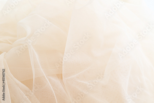 Fotografie light smooth beige tulle fabric background