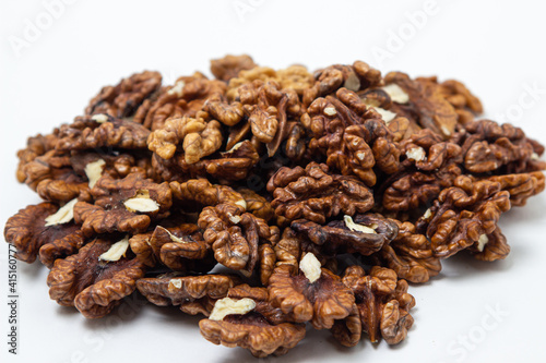 Peeled walnuts on a white background. A bunch of shelled walnuts. Nutritious food