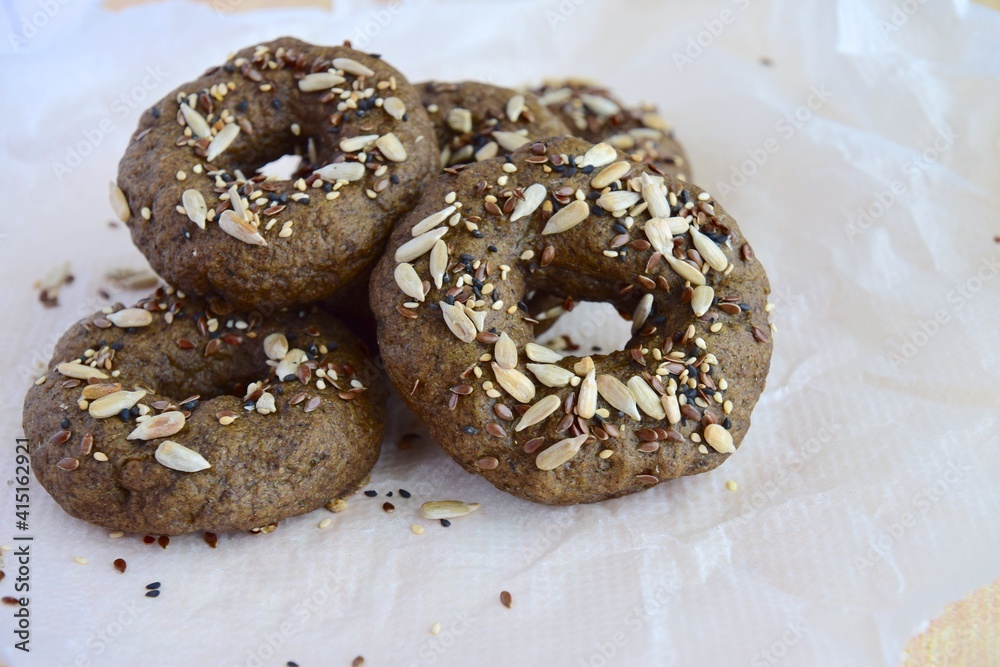 Vegan gluten free bagels topped with sunflower seeds, flax seeds and sesame seeds. Healthy breakfast food. 