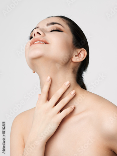 woman naked shoulders is face makeup close up