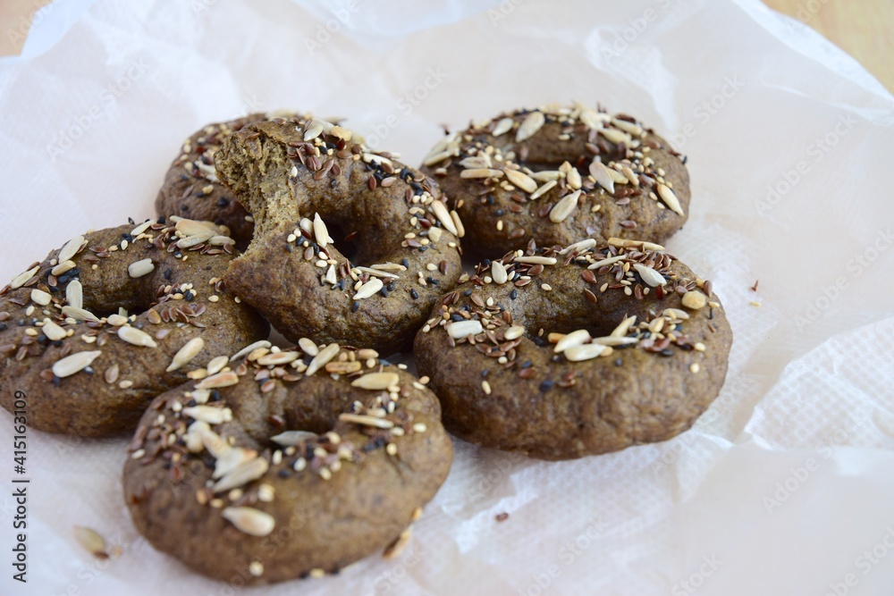 Vegan gluten free bagels topped with sunflower seeds, flax seeds and sesame seeds. Healthy breakfast food. 