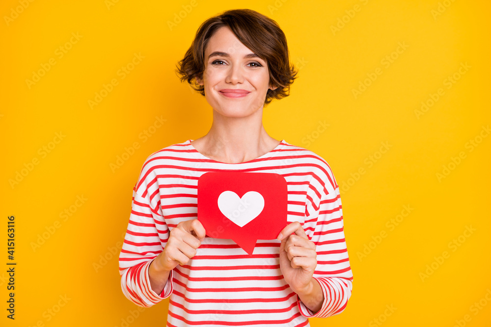 Photo of optimistic brunette lady hold like wear red shirt isolated on orange color background Photo of optimistic brunette lady hold like wear red shirt isolated on orange color background