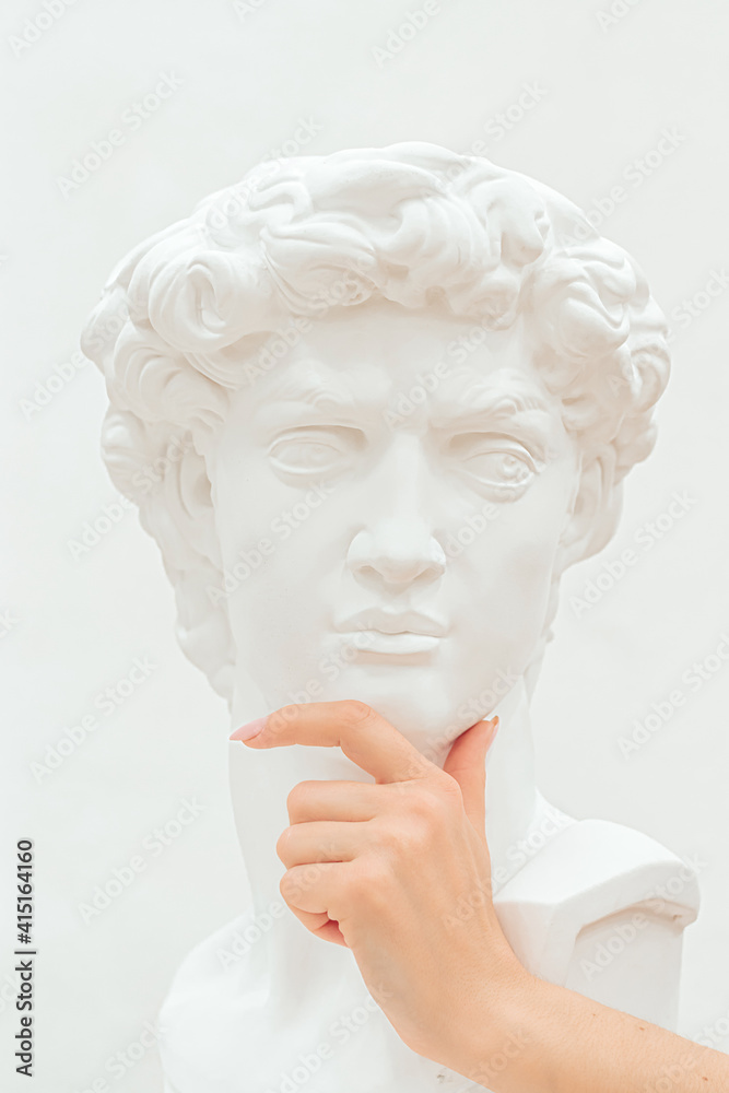 Women's hand holds a chin of the plastic sculpture of a man.Emotions, thoughtfulness,
creative concept. Women's hand holds a chin of the plastic sculpture of a man.Emotions, thoughtfulness,
creative concept.