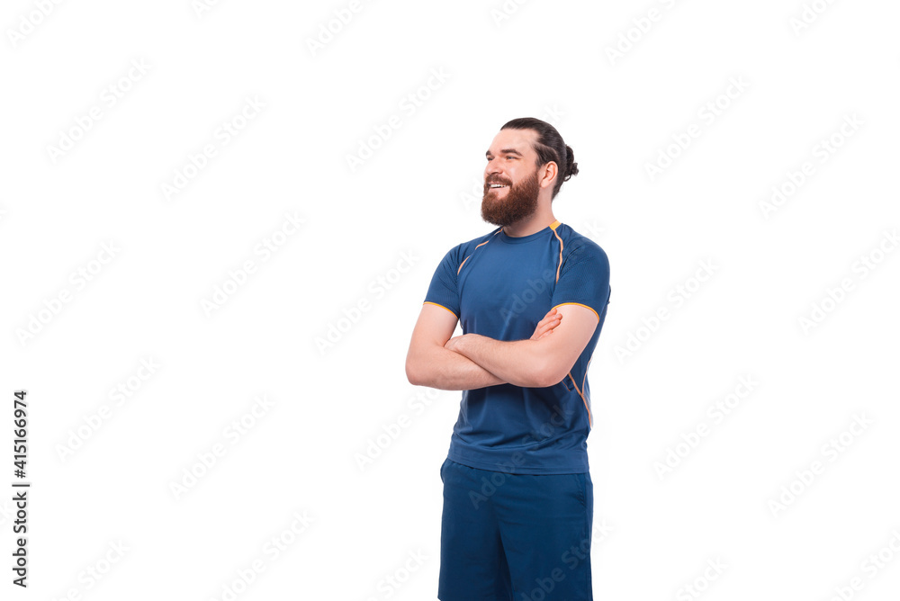 Cheerful handsome fitness man with crossed arms looking away over white background. Cheerful handsome fitness man with crossed arms looking away over white background.
