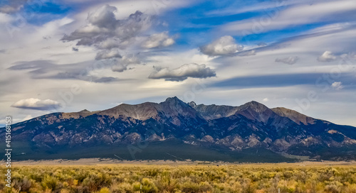 Yellow Prairie from Desert Plants, Great Sand Dunes National Park with mountains in the background, Colorado, US