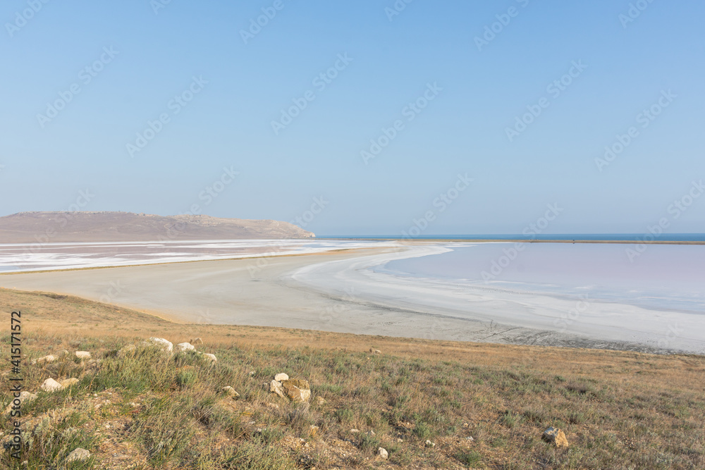 Koyash pink lake in the Crimea in the summer. Amazing delicate pastel landscape. The concept of relaxation, tranquility, and peace. Natural background in light neutral shades for design, layouts.
