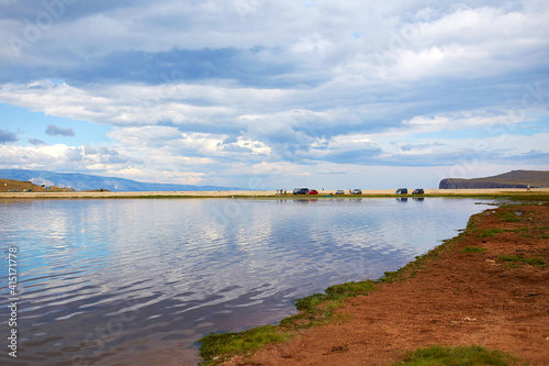 View of the lake on a cloudy summer day. Beautiful sky with clouds. A popular tourist destination.  © Viktoriya