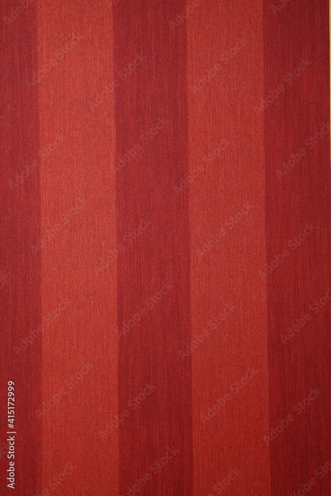 Fototapeta premium Close-up of a decorative element of the interior of a room - wallpaper: red striped background