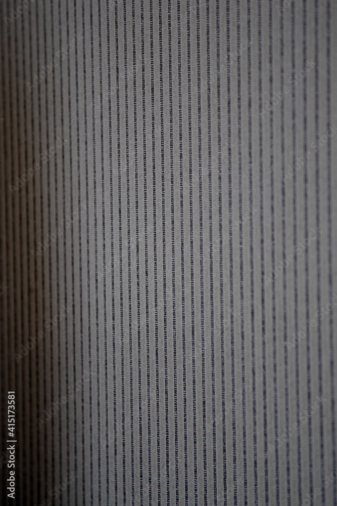 Close-up of a decorative element of the interior of the room - gray striped wallpaper. Can be used as background Close-up of a decorative element of the interior of the room - gray striped wallpaper. Can be used as background