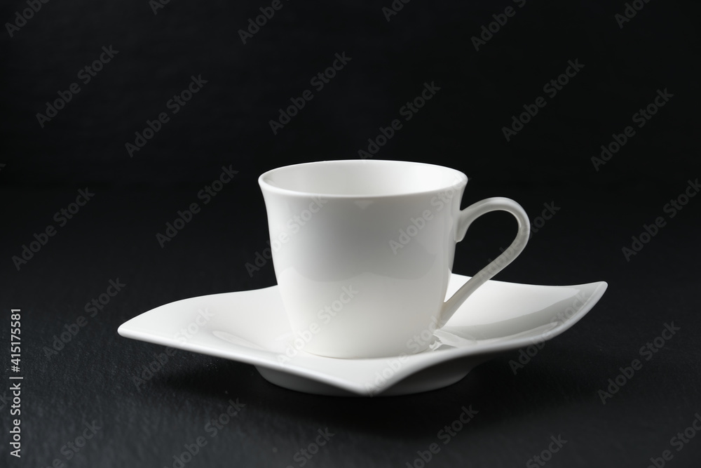 Empty white cup of coffee on black background Empty white cup of coffee on black background
