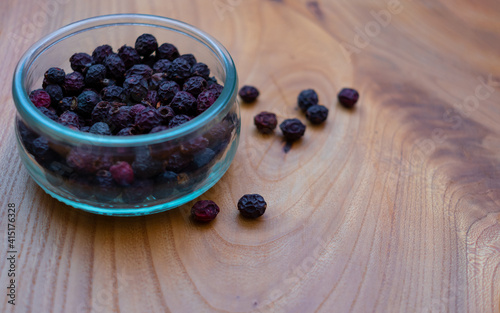 Dried fruits: wild rose, hawthorn in a glass jar on a wooden table-medicinal useful berries photo