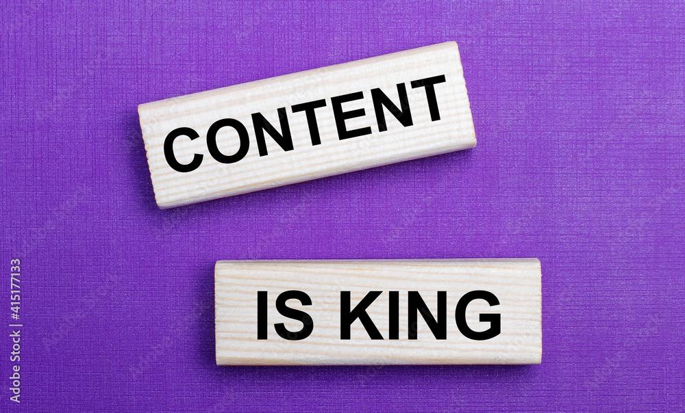 On a lilac bright background, light wooden blocks with the text CONTENT IS KING On a lilac bright background, light wooden blocks with the text CONTENT IS KING
