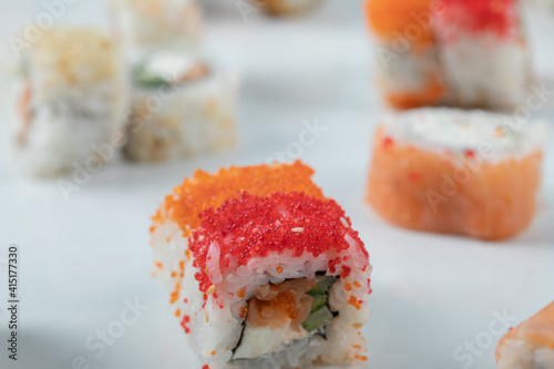 Sushi rolls with mixed ingredients on a white background