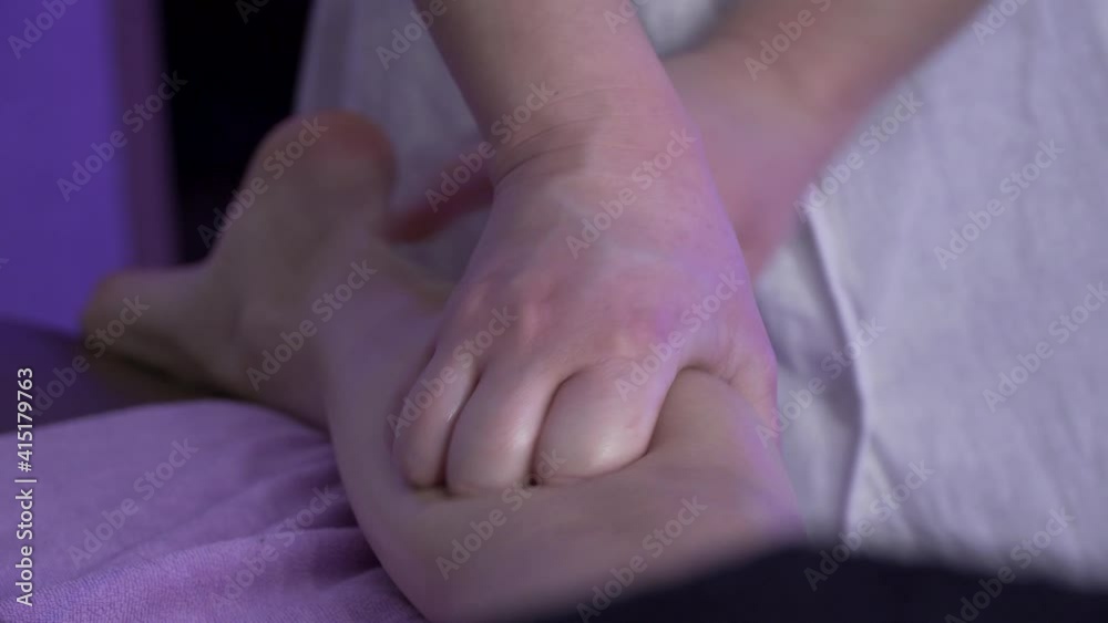 woman masseur makes massage to young european girl. Massages the calves on a special table. woman masseur makes massage to young european girl. Massages the calves on a special table.