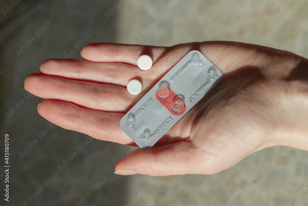 Two pills for emergency contraception on the hand of a woman Two pills for emergency contraception on the hand of a woman