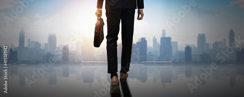 forward to success, back of confident businessman holding business document bag walk to achievement, future professional man leader move and step  to freedom of city and social photo