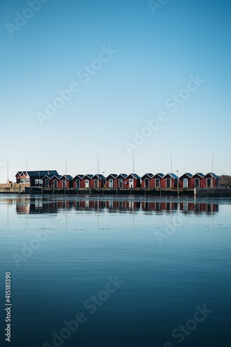 Small red sheds by the ocean photo