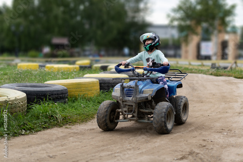 a child rides an ATV on the track © Alexander Gogolin