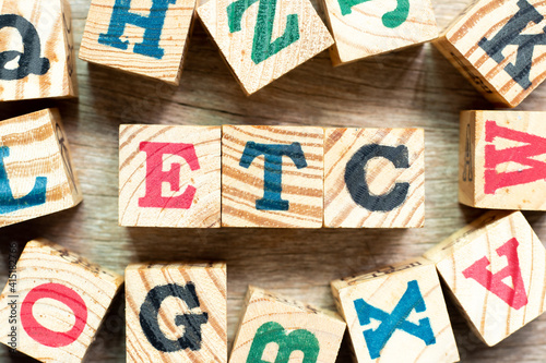 Alphabet letter block in word etc (abbreviation of et cetera) with another on wood background