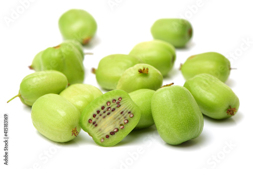 mini kiwi baby fruit (actinidia arguta) on white background 