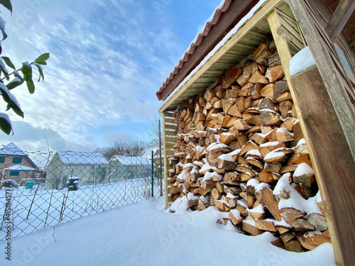 Firewood piled up in the snow  photo