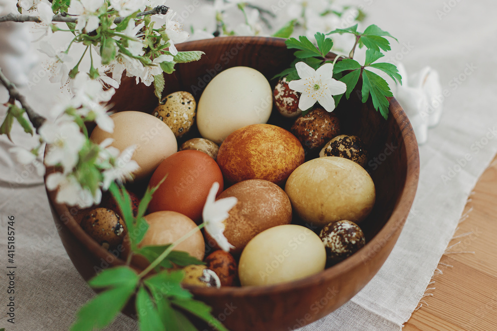 Happy Easter! Stylish easter eggs in wooden bowl on rustic table with bunny and spring flowers. Happy Easter! Stylish easter eggs in wooden bowl on rustic table with bunny and spring flowers.