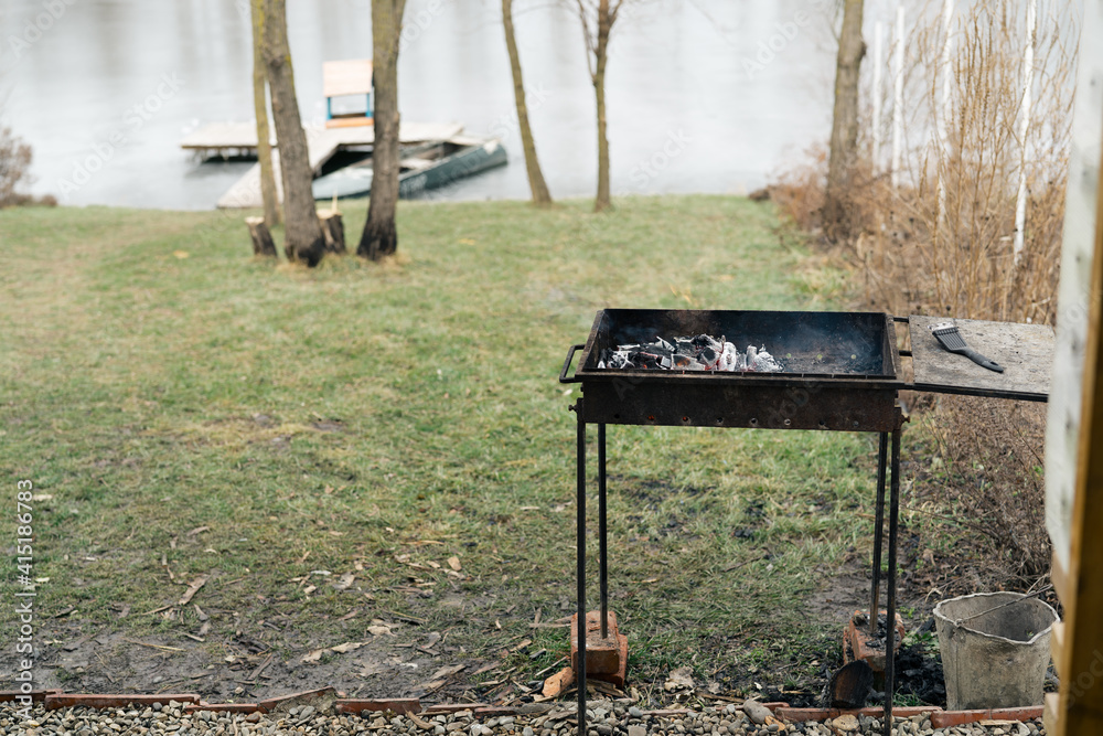barbecue in nature near the river and trees In the background, cooking