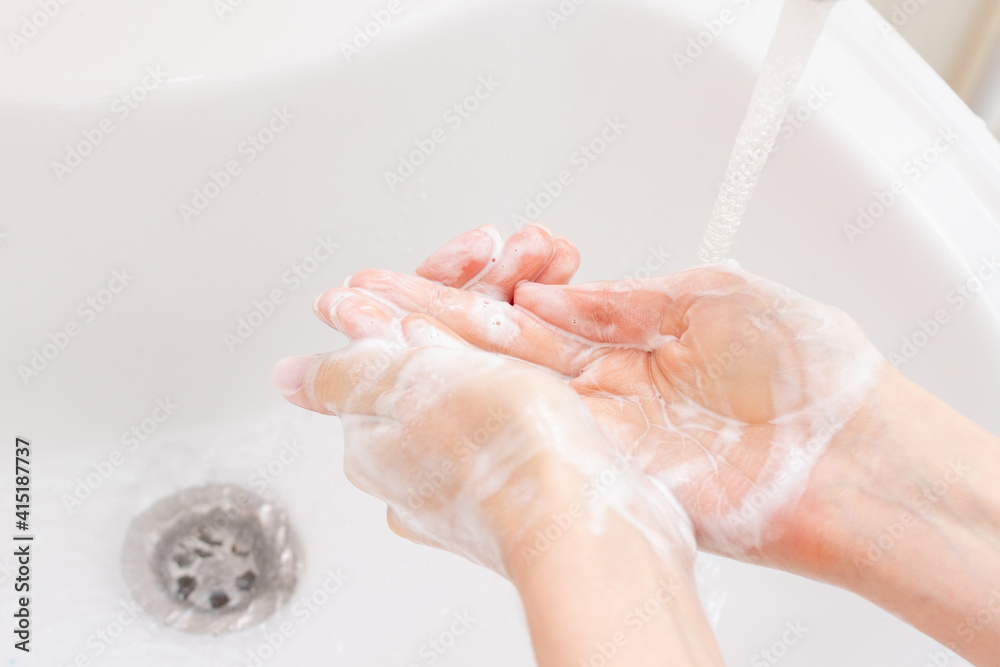 Woman washing hands in bathroom. Health care Woman washing hands in bathroom. Health care