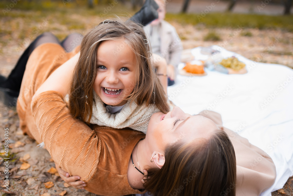 Family have fun and enjoy a picnic outdoors