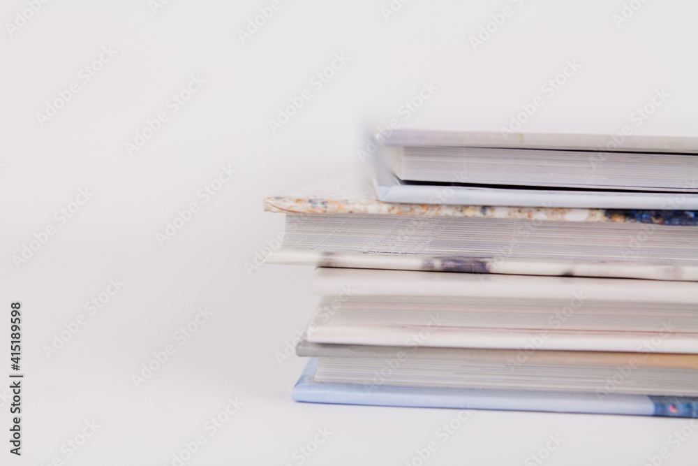 books are in a pile on top of each other on a white background