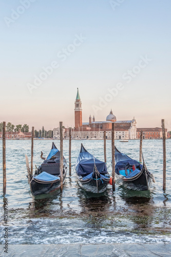 Italy, Venice. Gondolas on the waterfront with San Giorgio Maggiore Church in the background