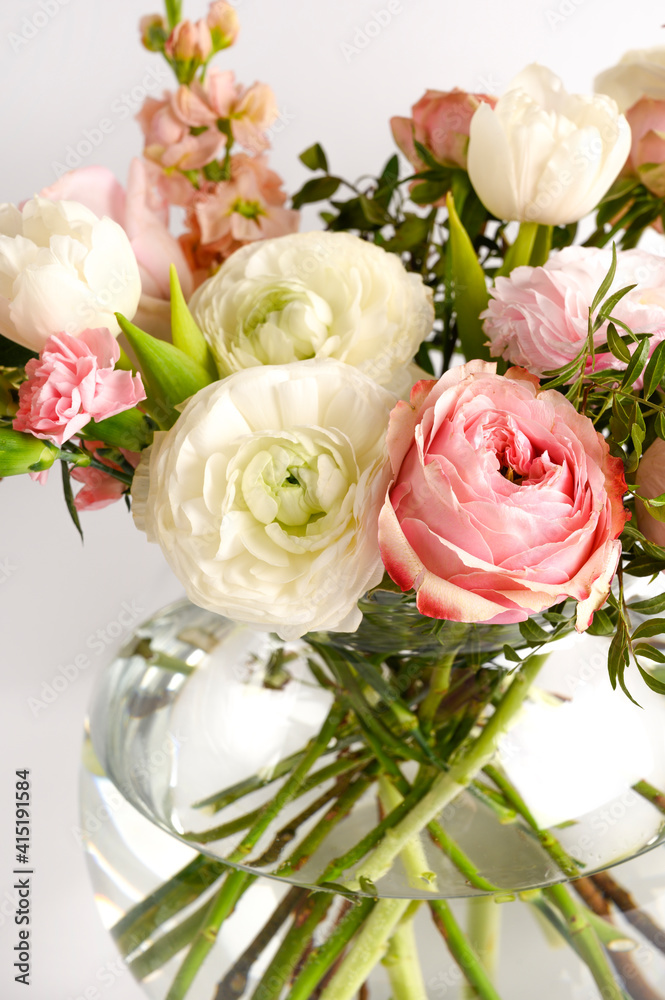 Beautiful flowers in vase on a table with white background. Women's, mother's day, love concept. Spring, summer season. Beautiful flowers in vase on a table with white background. Women's, mother's day, love concept. Spring, summer season.