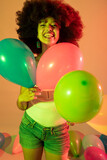 Young beautiful multiethnic woman studio shot posing with balloon