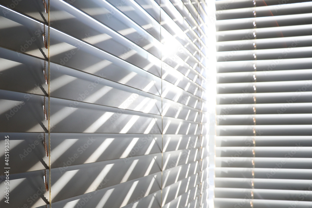 Bright sunshine seen through venetian blinds Bright sunshine seen through venetian blinds