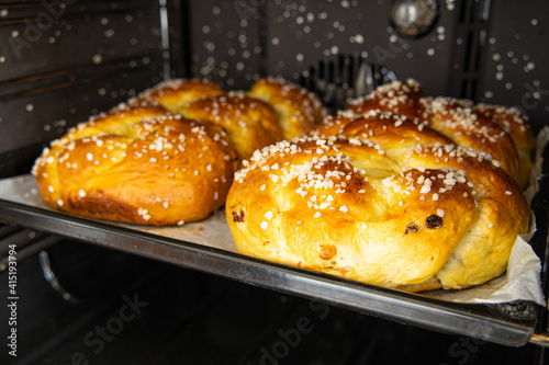 Typical traditional Austria: 2 Allerheiligenstriezel on a tin sheet and paper are finished in the open cooker photo