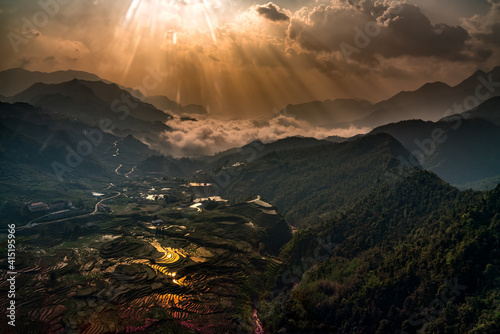 Sprawling Rice fields aerial shot during sunrise. This one has it all, mountains, light rays, reflections, sunrise colors, rice fields, dramatic clouds in the valley beyond. © KAPhotography