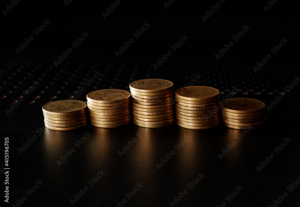 stacks of gold coin on black background concept saving money stacks of gold coin on black background concept saving money