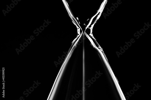 The sand flows in the hourglass.