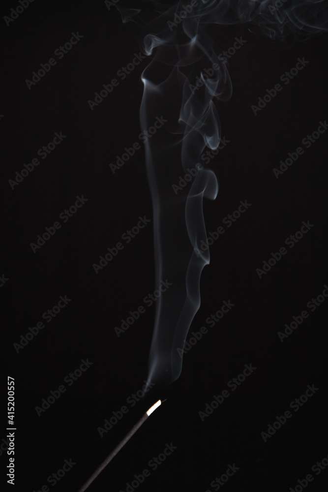 Incense burning giving of different patterns of smoke Incense burning giving of different patterns of smoke