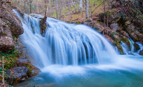 beautiful waterfall falling from huge stone