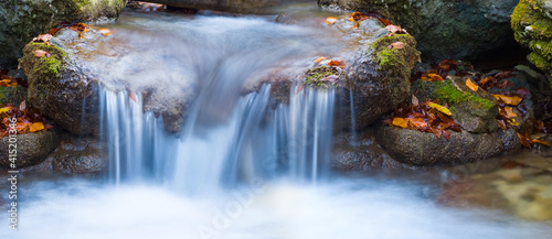 closeup water stream fall from a stone  water natural background