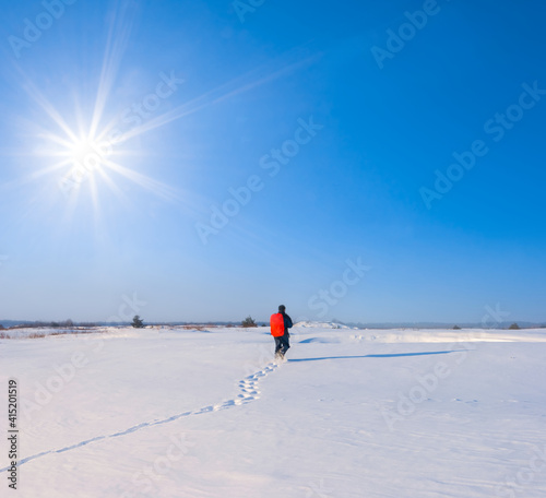 hiker walk among snowbound plain