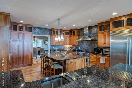 Beautiful expensive kitchen with granite  tile  and high end appliances.
