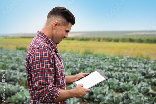 Man using tablet in field. Agriculture technology