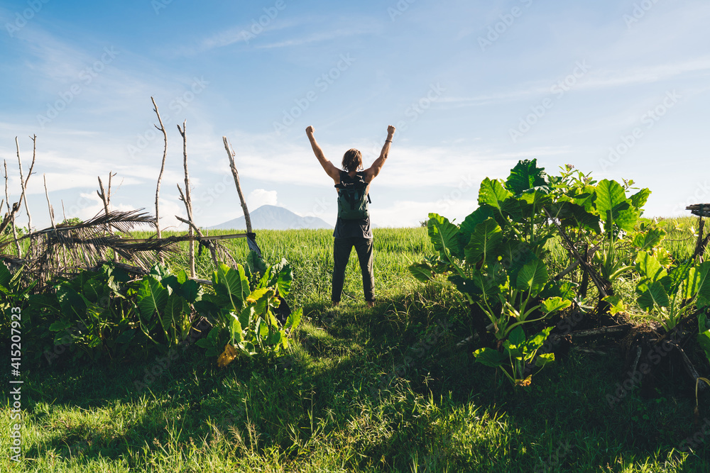Unrecognizable man standing in green field Unrecognizable man standing in green field