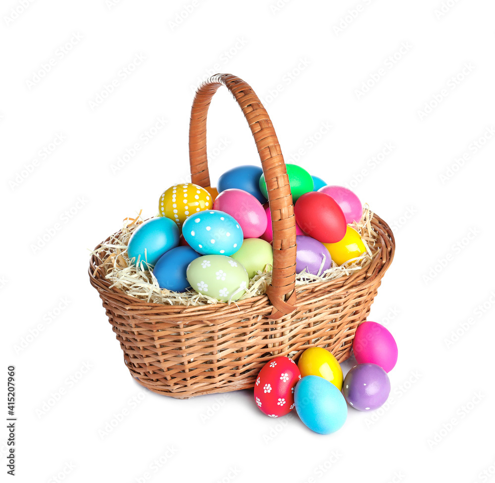 Wicker basket with bright painted Easter eggs on white background Wicker basket with bright painted Easter eggs on white background