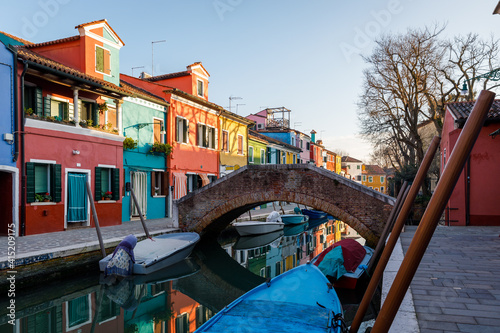 Burano island with colorful houses and boats in winter afternoon