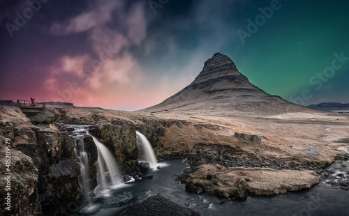 Northern lights aurora borealis over kirkjufell waterfall in Iceland © surangaw